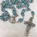 Pope Francis Aqua Colored Crystal Bead Rosary features Pope Francis' crest and Papal Crucifix. From Italy.