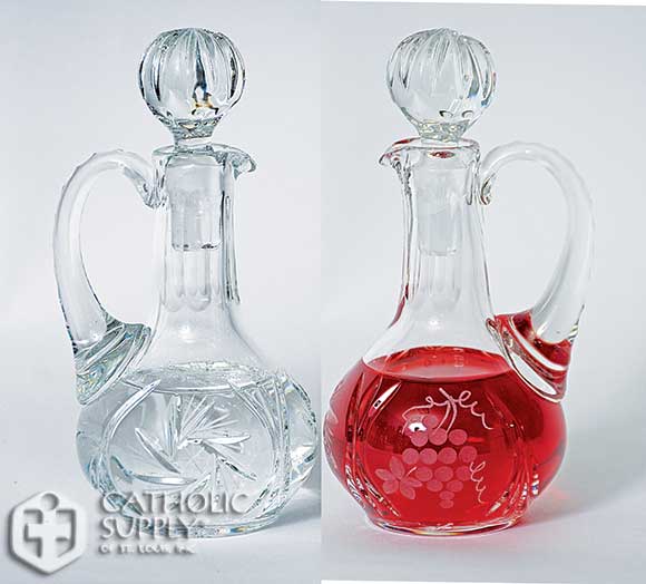 Crystal Cruet Set 6-3/8" H., 6 oz. cap. ?Grape and leaf design on wine, ?pinwheel design on water.
